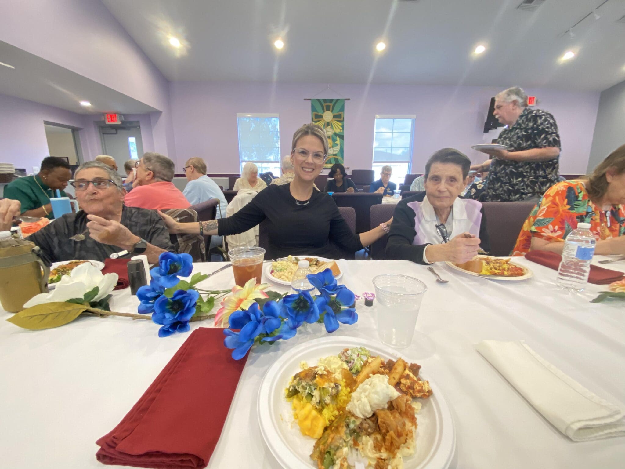 People enjoying a meal together at a decorated table indoors.