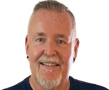 Smiling man with light hair and a goatee.