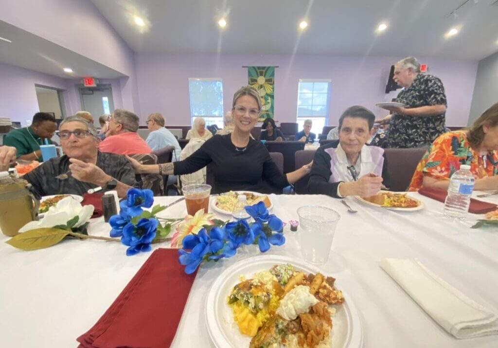 People enjoying a meal together at a decorated table indoors.